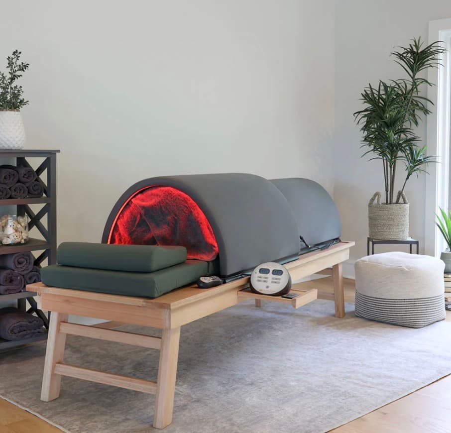 Infrared sauna dome with red light therapy in a calm wellness treatment room